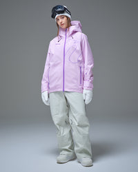 Full-body view of a woman wearing a pink NOBADAY GORE-TEX snow jacket and white snow pants