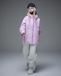 Woman wearing a pink NOBADAY GORE-TEX snow jacket with white snowboard pants