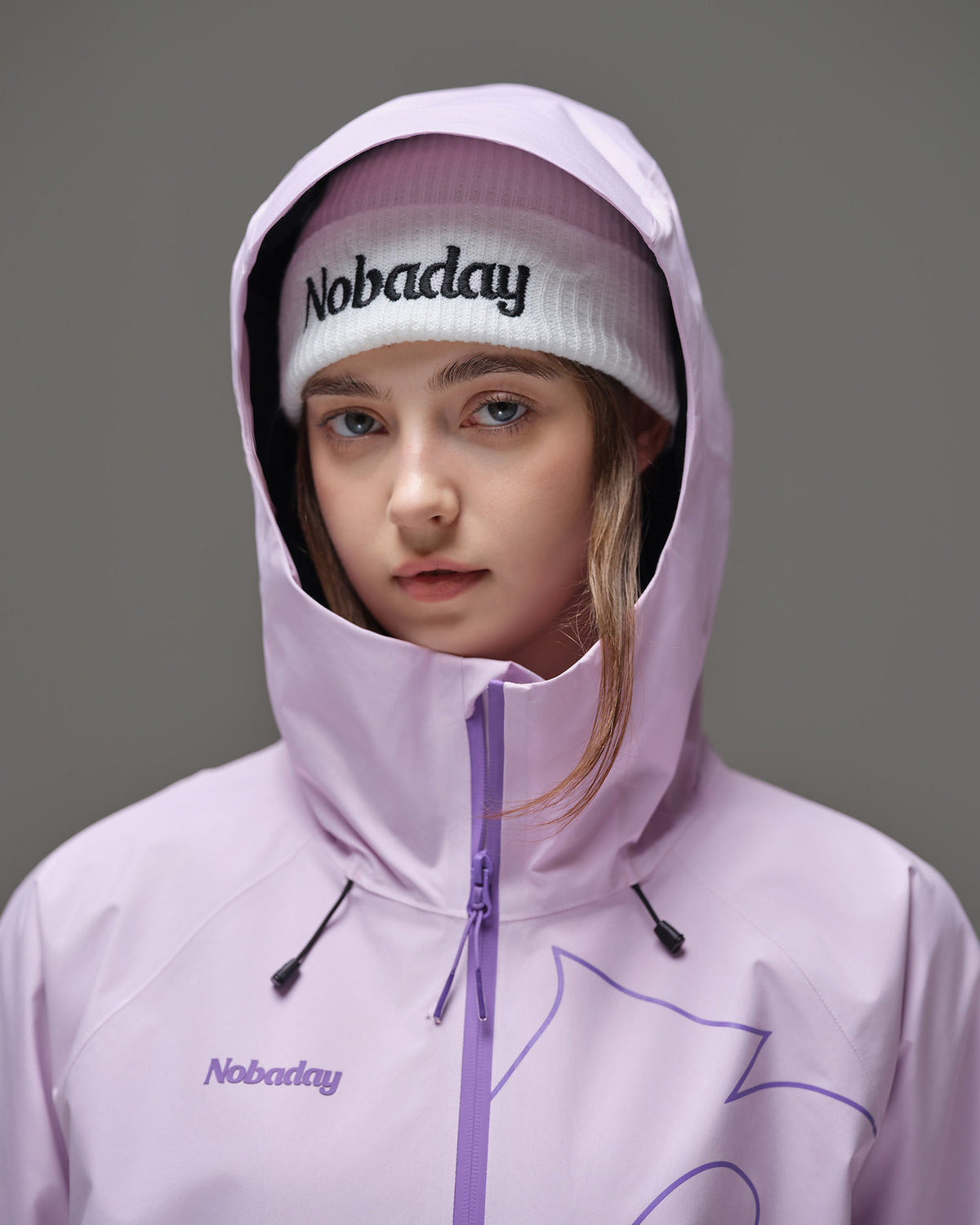 Close-up of the adjustable hood and high collar on a pink NOBADAY women’s snow jacket