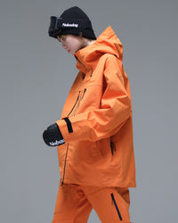 Side view of the NOBADAY Women's Pure Free 3L orange snow jacket showing the hood, adjustable cuff, and technical silhouette