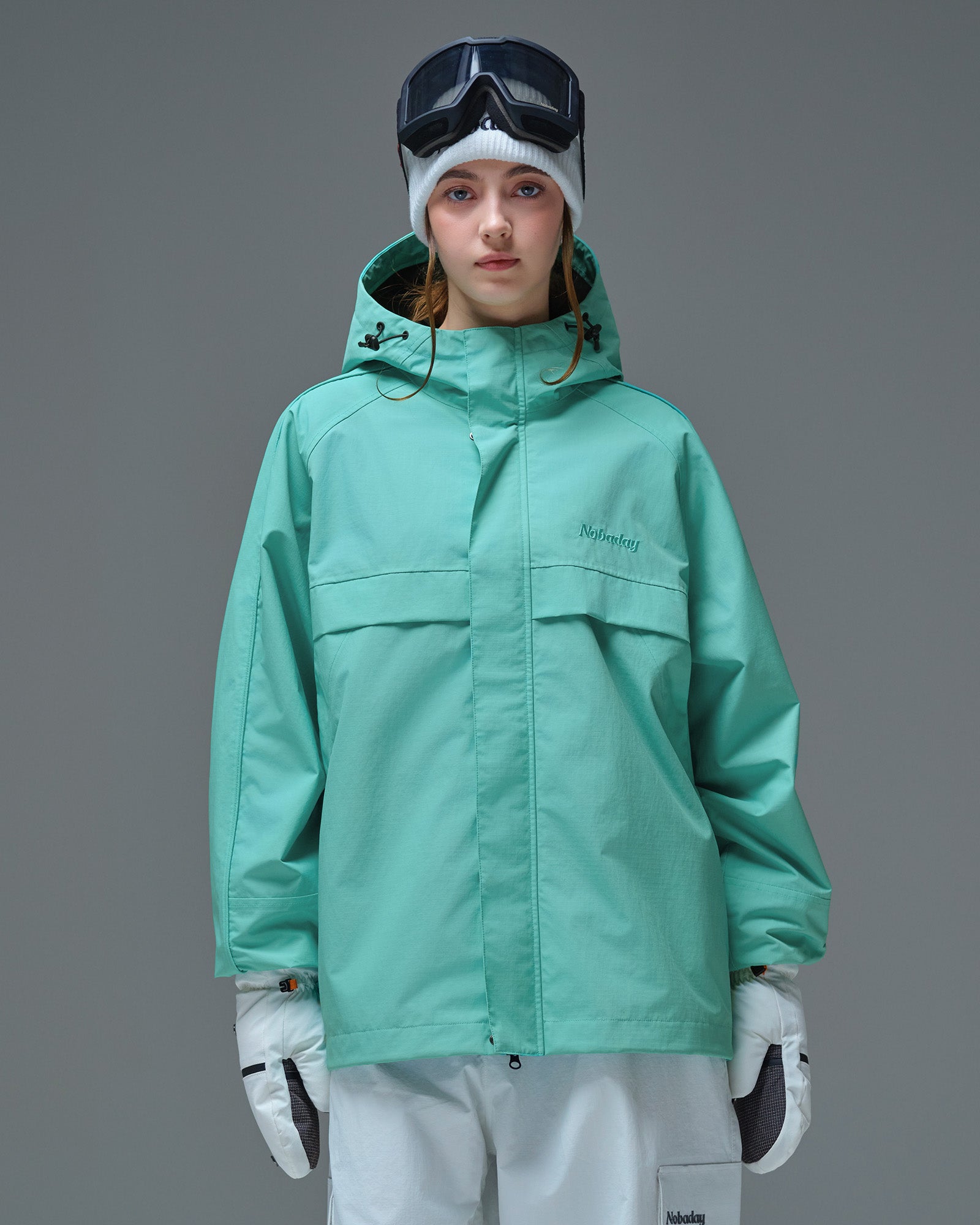 Front view of Nobaday Women's Pure Free Active blue snow jacket with storm flap, adjustable hood, oversized sleeves, and waterproof shell