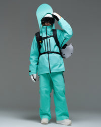 Woman wearing the Nobaday Pure Free Apex 3L waterproof breathable snow jacket in blue with snowboard gear and a helmet