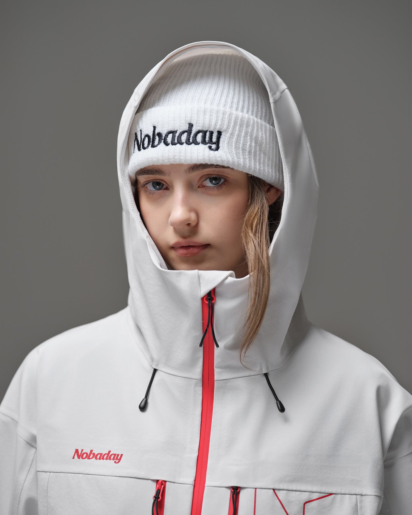 Protective hood and high collar detail on the Nobaday Women's Pure Free Apex 3L waterproof snow jacket in white