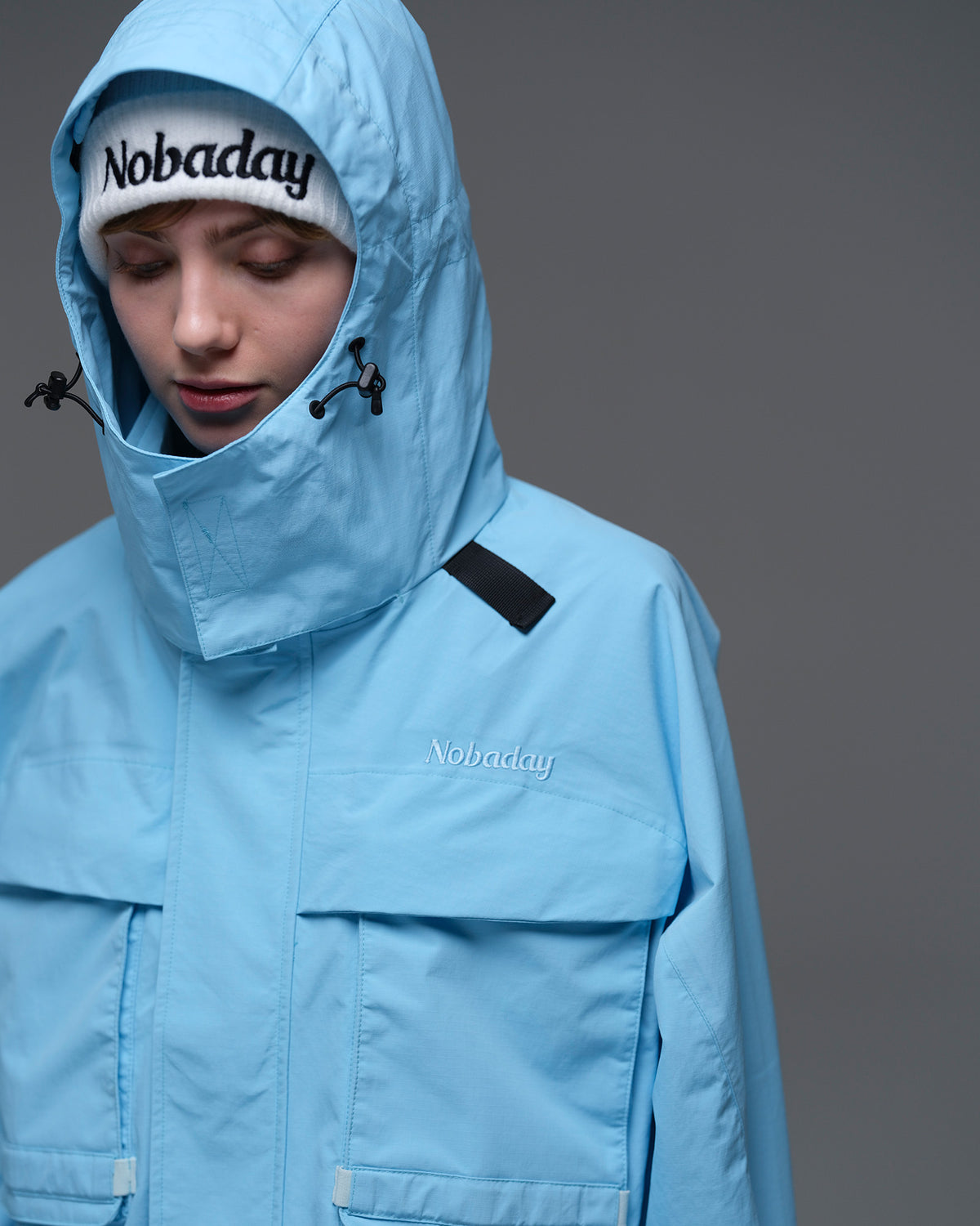 Close-up of the adjustable hood and high collar on the sky blue Nobaday Women’s Pure Free Drift Snow Jacket