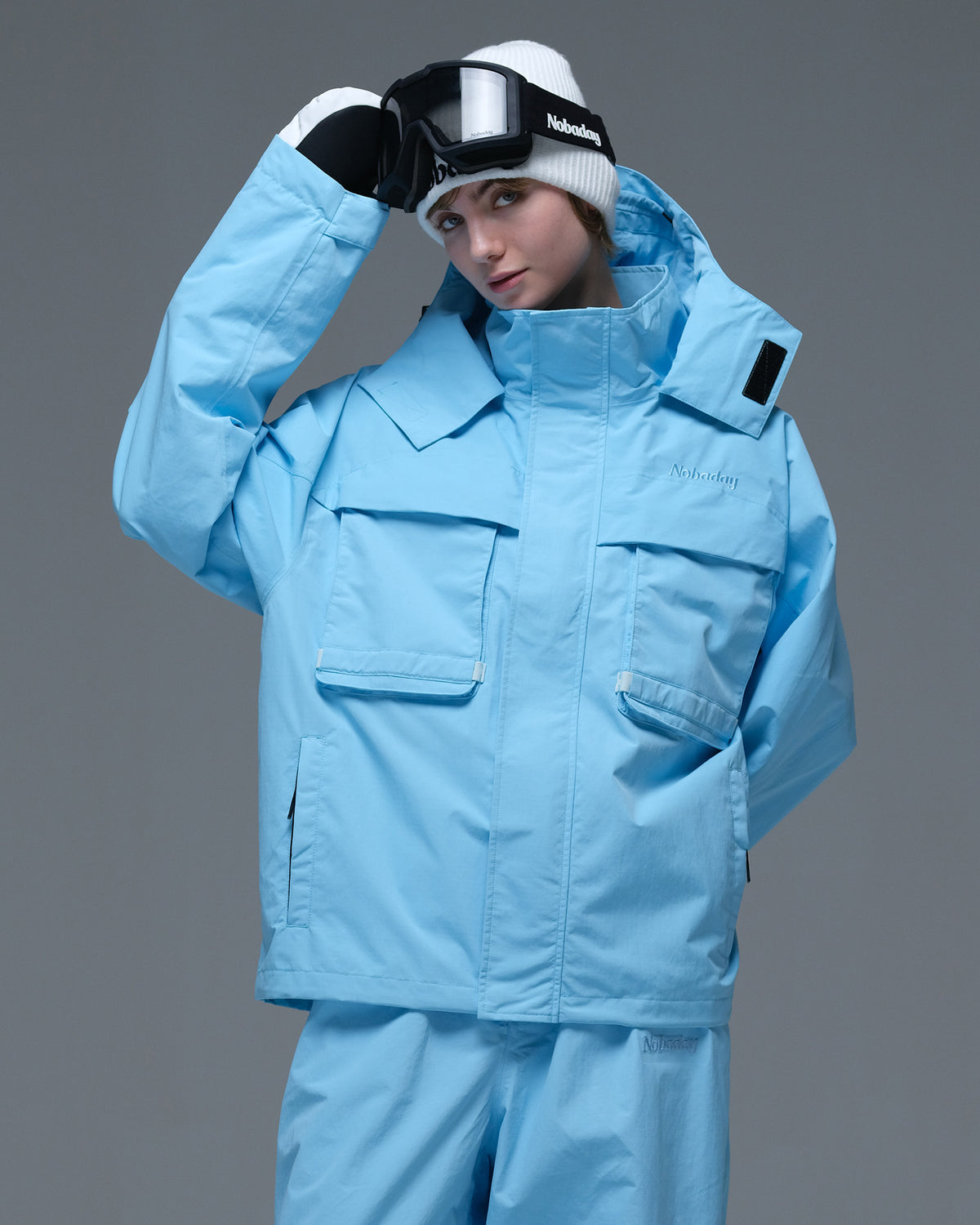 Front view of the sky blue Nobaday Women’s Pure Free Drift Snow Jacket featuring a high collar and large flap pockets