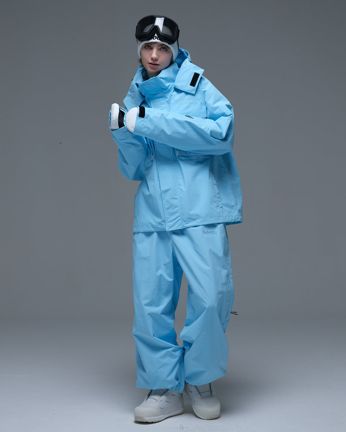 Full-body view of the sky blue Nobaday Women’s Pure Free Drift Snow Jacket styled with matching blue snow pants