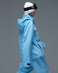 Side view of the sky blue Nobaday Women’s Pure Free Drift Snow Jacket showing the hood and oversized utility-pocket design