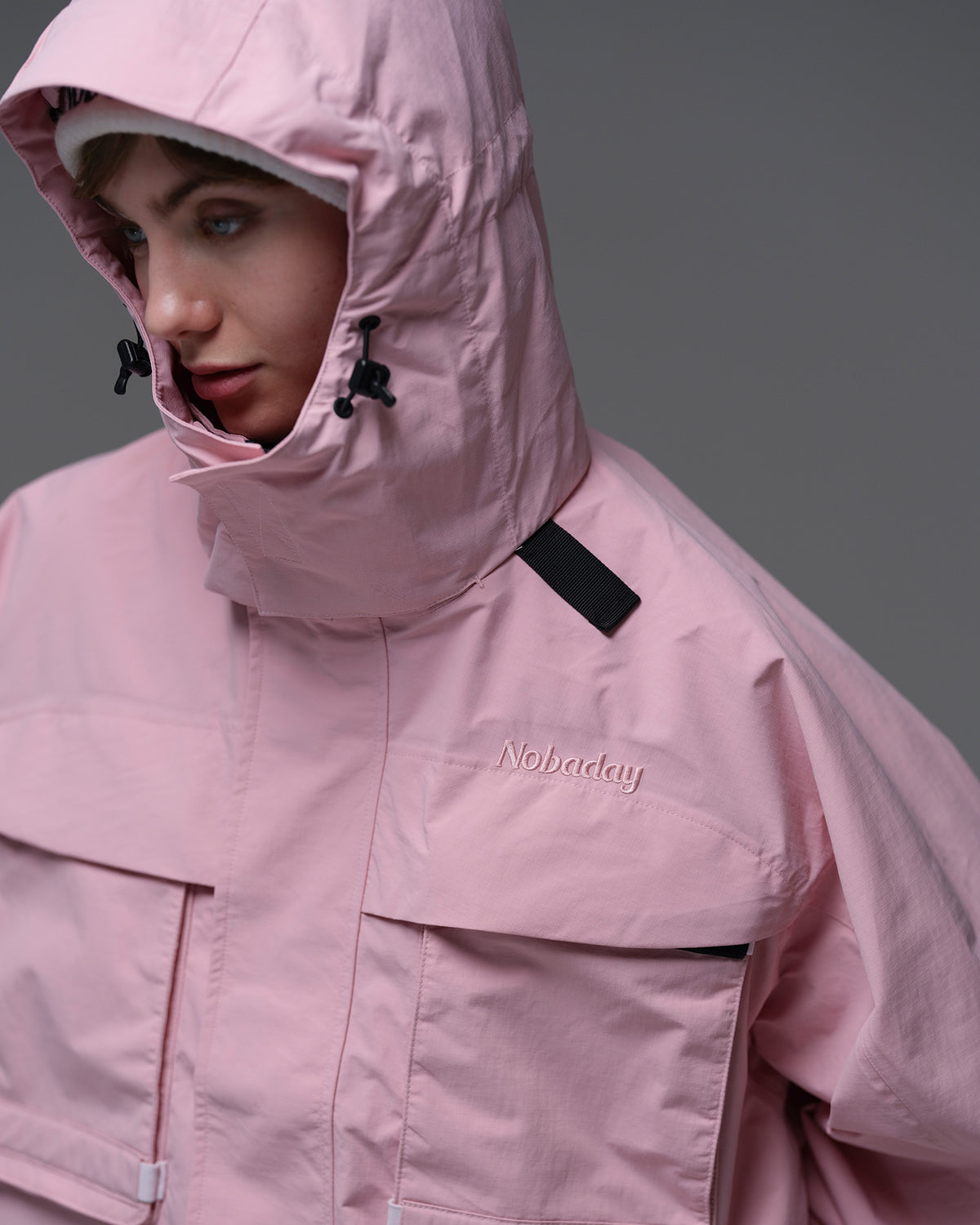 Close-up of the adjustable hood and high collar on the pink Nobaday Women’s Pure Free Drift Snow Jacket