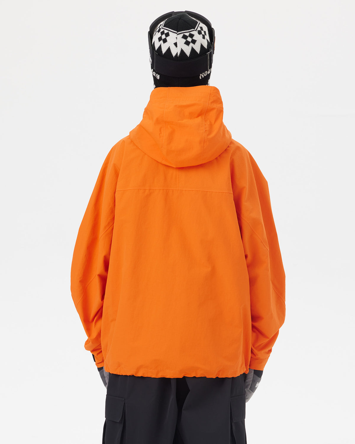 Back view of the NOBADAY Women's Pure Free Freestyle orange snow jacket showing the protective hood and oversized silhouette