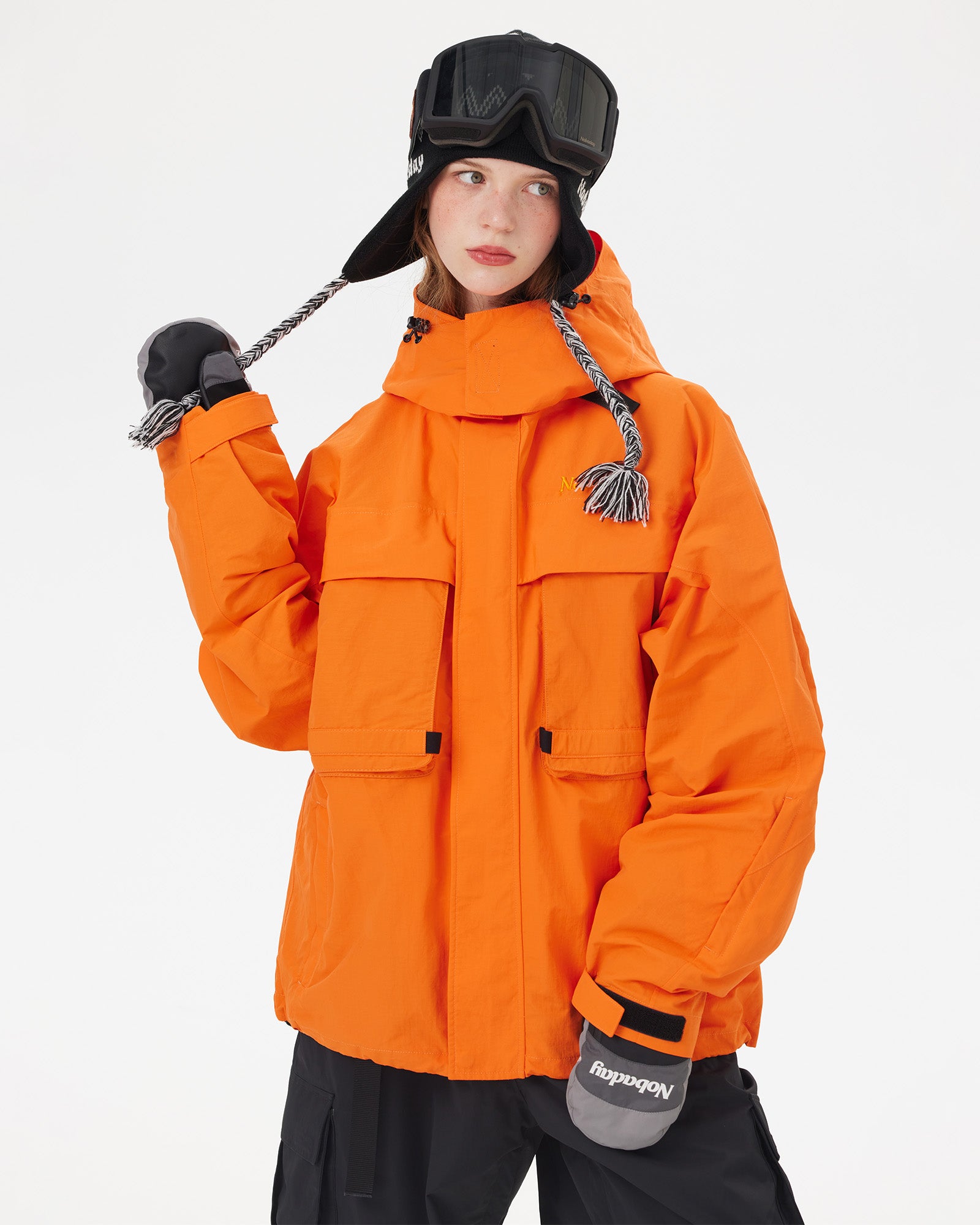 Front view of the NOBADAY Women's Pure Free Freestyle orange snow jacket with utility chest pockets and adjustable cuffs
