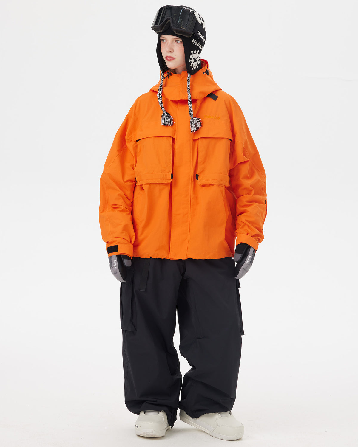 Full-body front view of the NOBADAY Women's Pure Free Freestyle orange waterproof snow jacket with an oversized fit