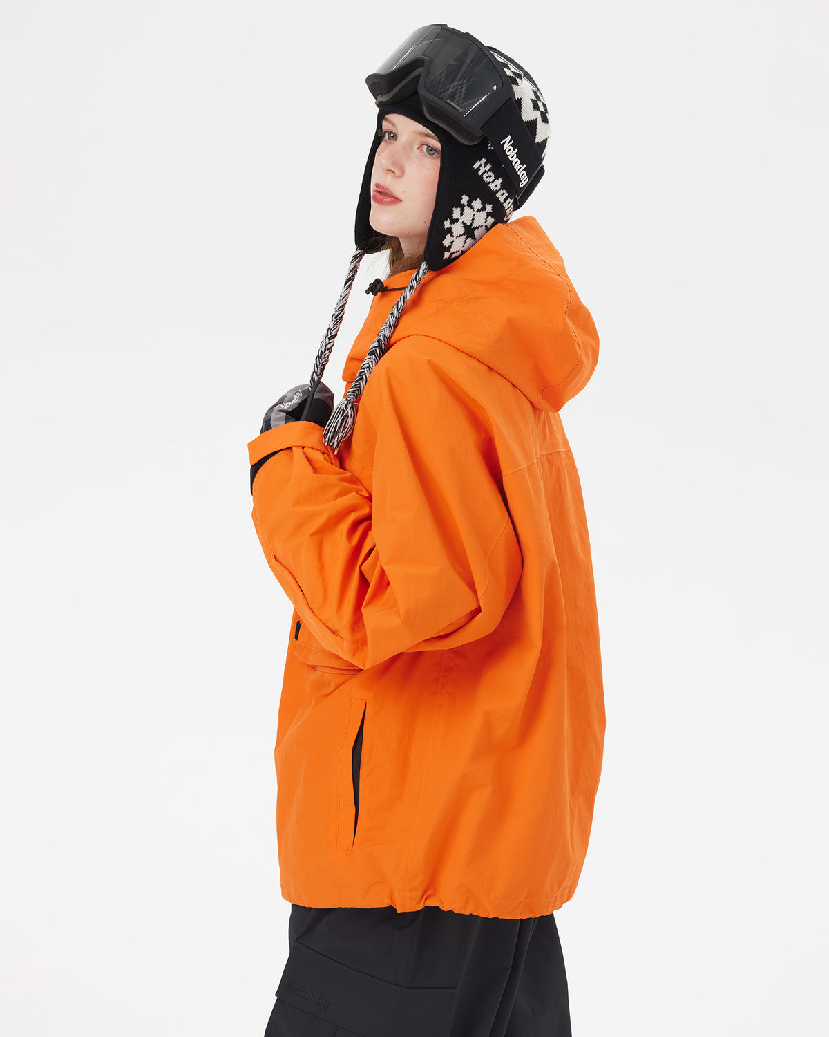 Side view of the NOBADAY Women's Pure Free Freestyle orange waterproof snow jacket with an adjustable hood and relaxed fit
