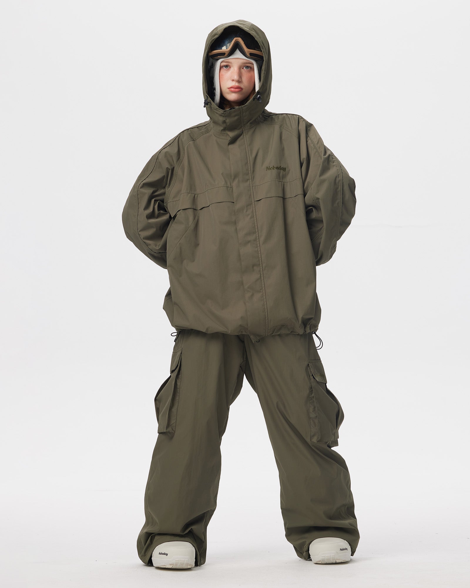 Full body front view of Nobaday Women's Pure Free green snow jacket with matching snow pants, oversized fit, and adjustable hood