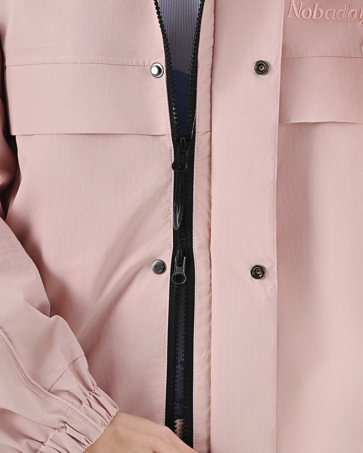 Front zipper and snap-button storm flap detail on the Nobaday Women's Pure Free Snow Jacket in pink