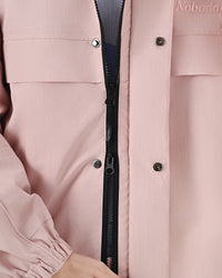 Front zipper and snap-button storm flap detail on the Nobaday Women's Pure Free Snow Jacket in pink