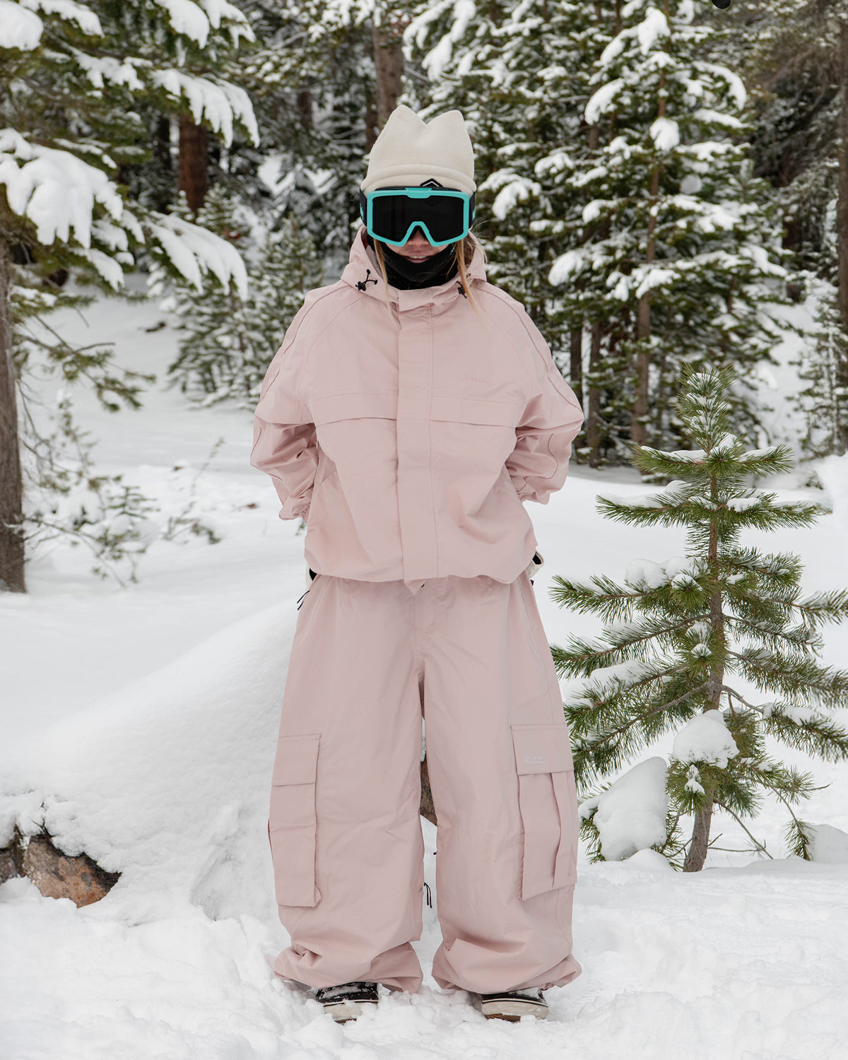 Woman wearing the Nobaday Women's Pure Free Snow Jacket in pink in a snowy forest