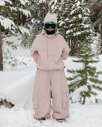 Woman wearing the Nobaday Women's Pure Free Snow Jacket in pink in a snowy forest