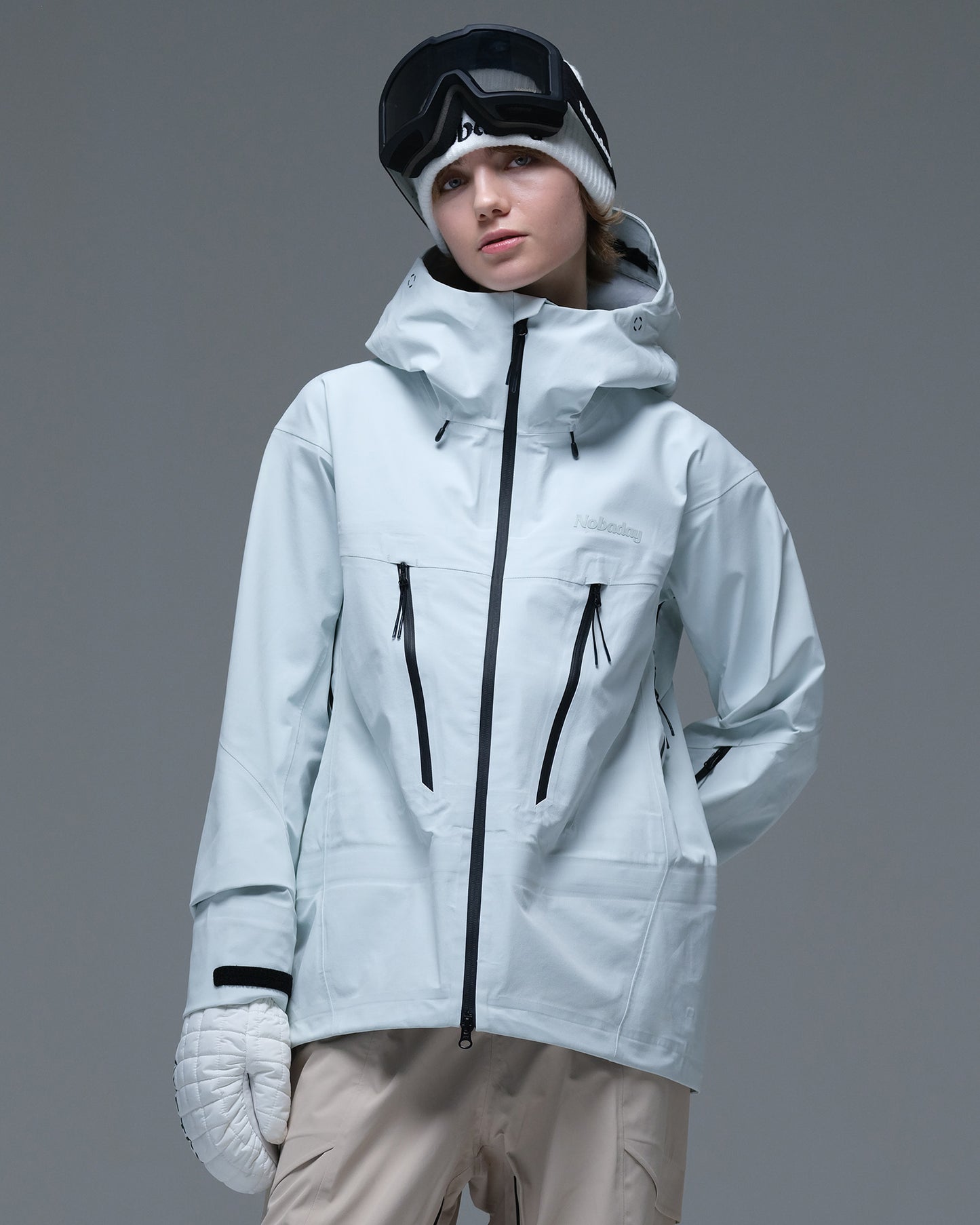 Front view of the ice blue Nobaday Women’s Snowshield Pro 3L Snow Jacket featuring contrasting black zippers and an adjustable hood.