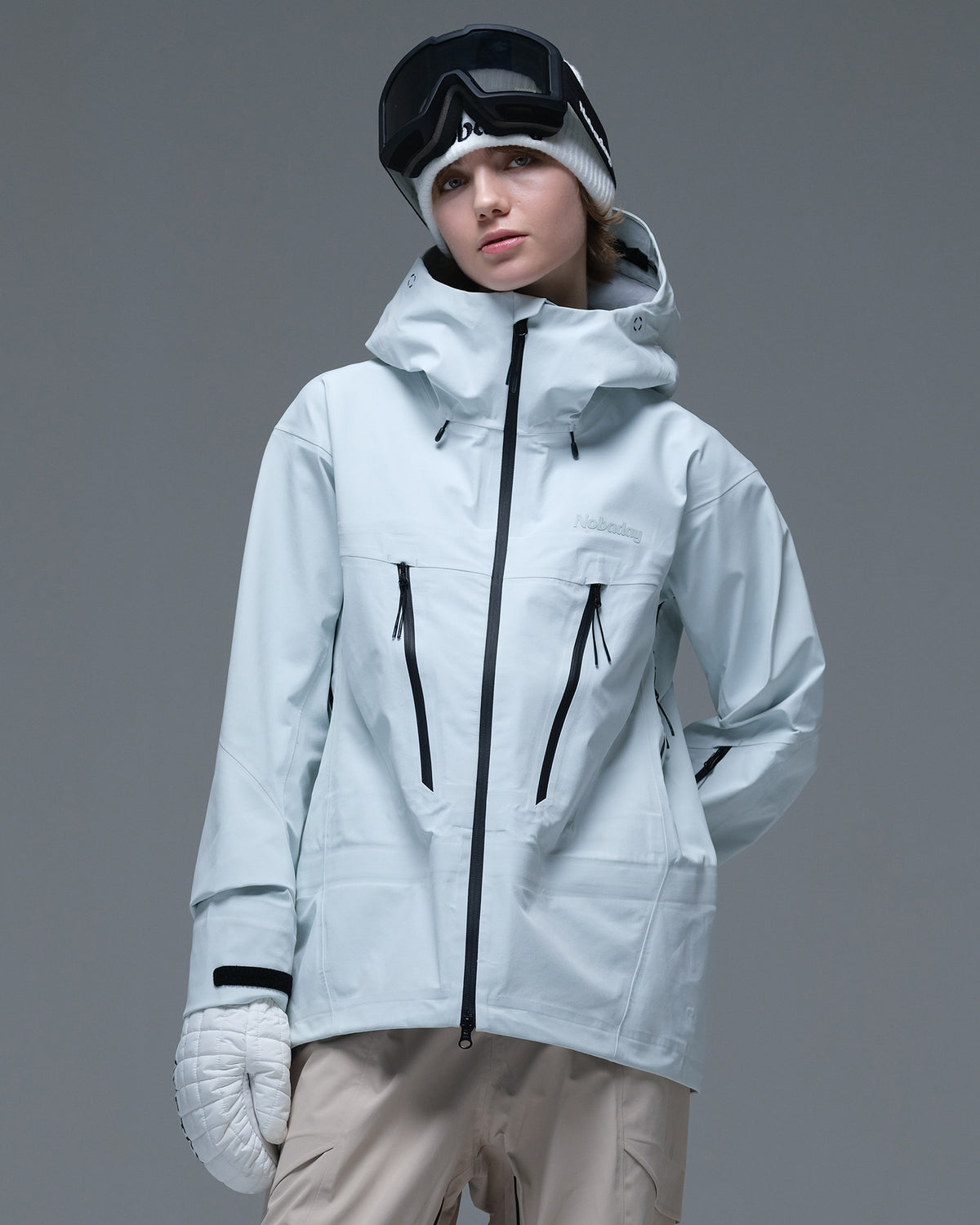 Front view of the ice blue Nobaday Women’s Snowshield Pro 3L Snow Jacket featuring contrasting black zippers and an adjustable hood.