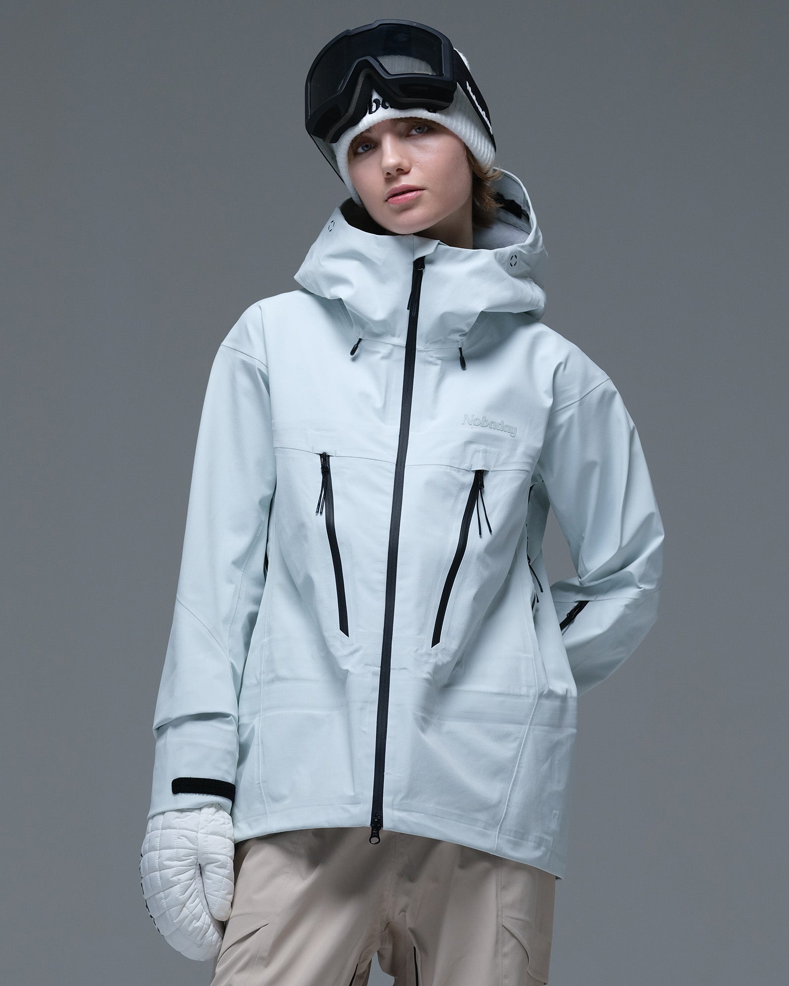 Front view of the ice blue Nobaday Women’s Snowshield Pro 3L Snow Jacket featuring contrasting black zippers and an adjustable hood.