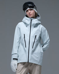 Front view of the ice blue Nobaday Women’s Snowshield Pro 3L Snow Jacket featuring contrasting black zippers and an adjustable hood.