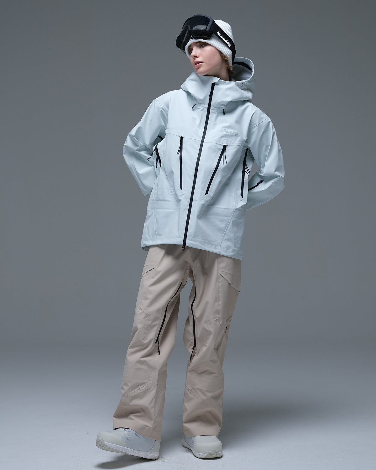 Full-body view of the ice blue Nobaday Women’s Snowshield Pro 3L Snow Jacket featuring a protective hood and multiple zippered pockets