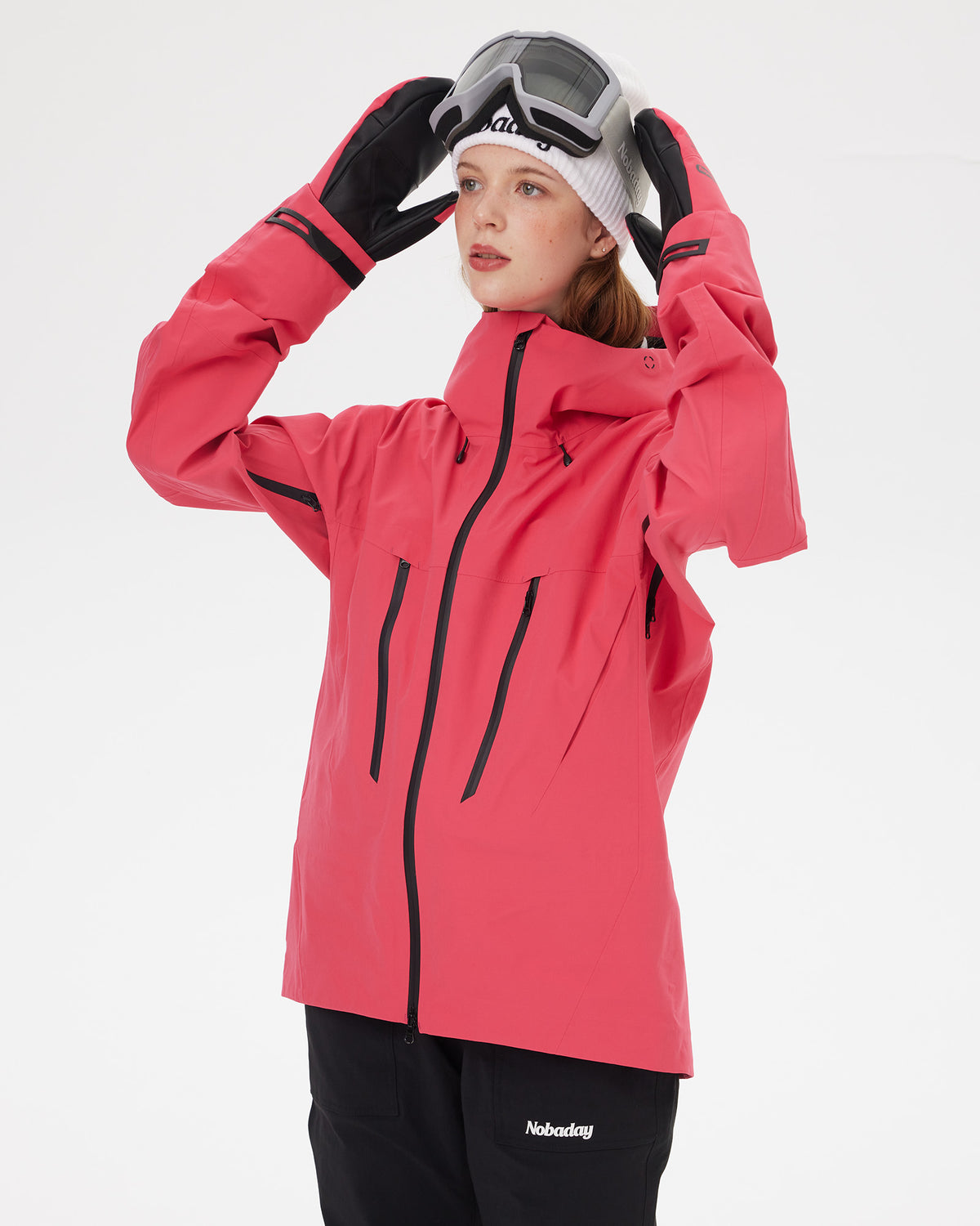 Woman adjusting ski goggles while wearing the NOBADAY Women's SnowShield Pro 3L red waterproof snow jacket