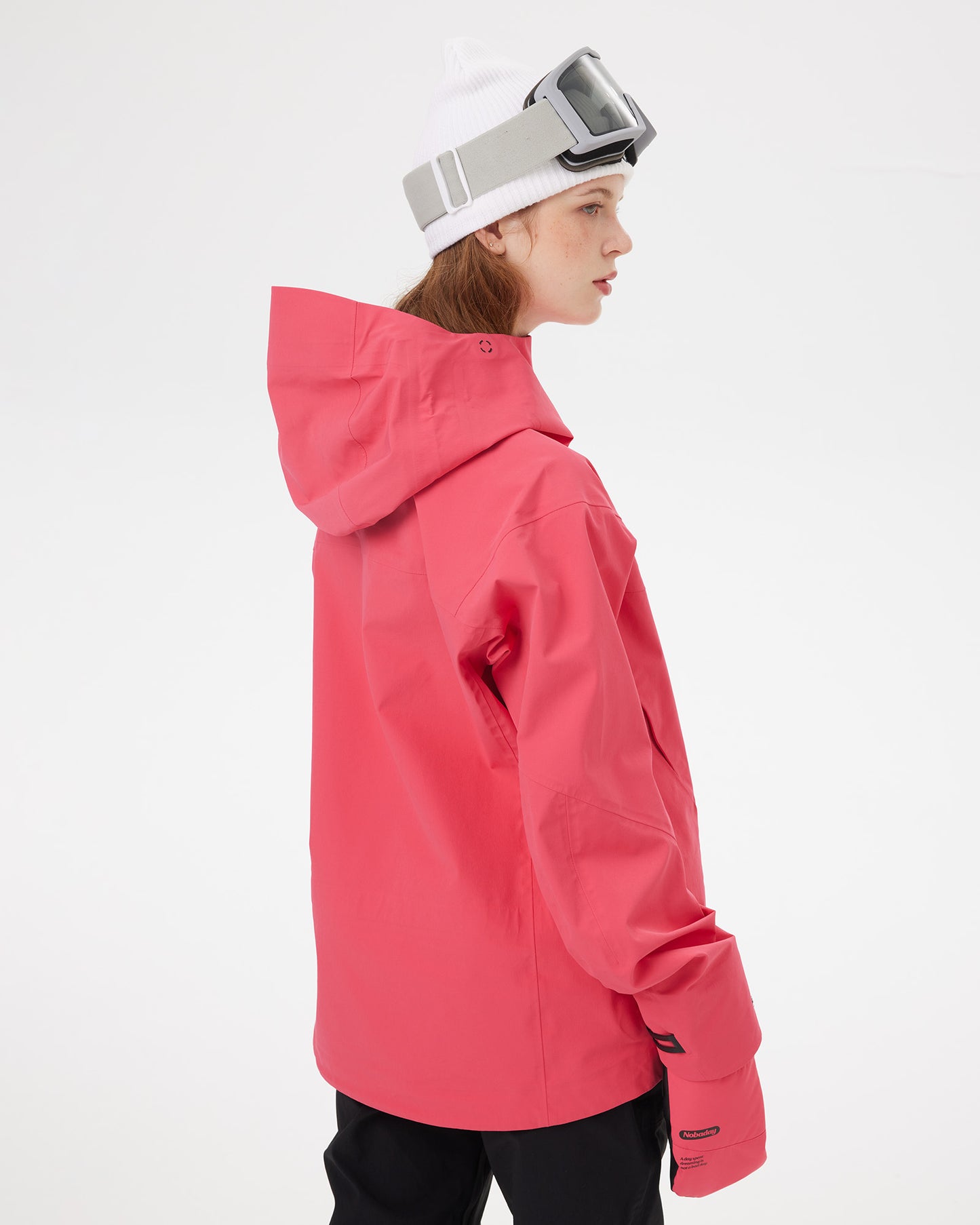 Rear three-quarter view of the NOBADAY Women's SnowShield Pro 3L red snow jacket showing the protective hood and relaxed fit