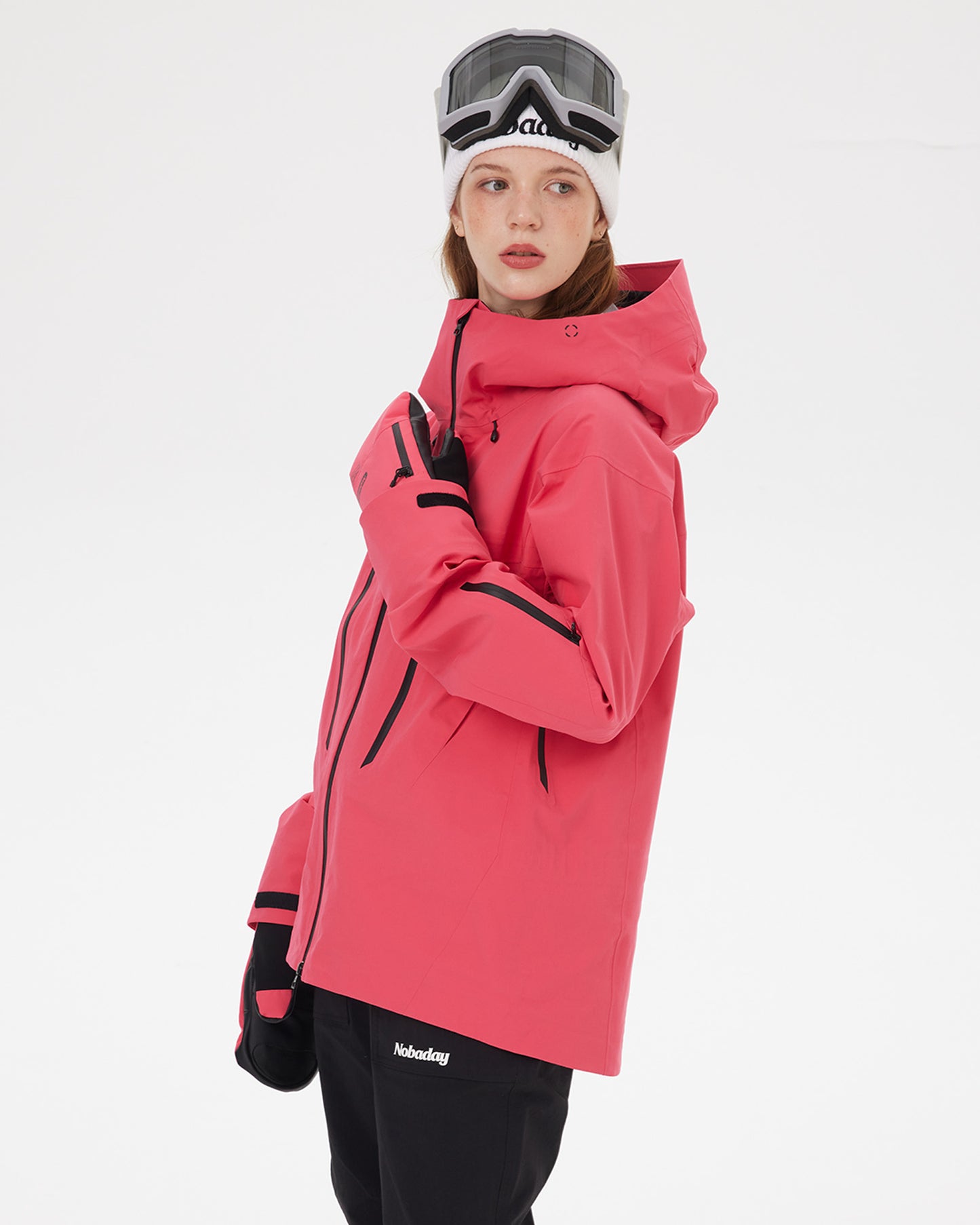 Side view of the NOBADAY Women's SnowShield Pro 3L red waterproof ski jacket with hood, sleeve pocket, and zippered vents