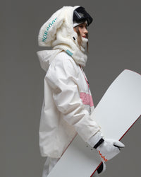 Side view of the ivory and pink Nobaday Women’s Juicy Candy Retro Snow Jacket styled with snowboard gear